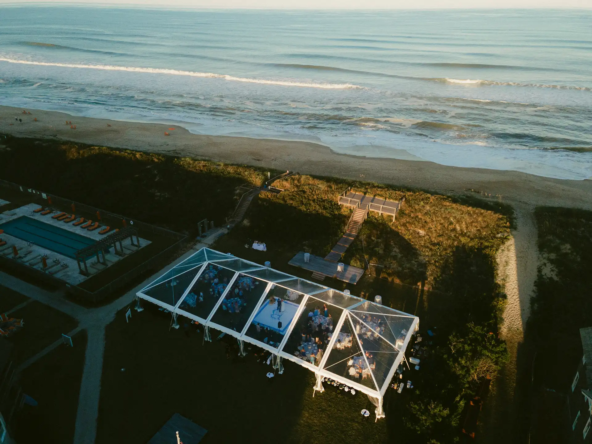 Aerial view of The Lawn, an outdoor wedding venue with stunning beach views.