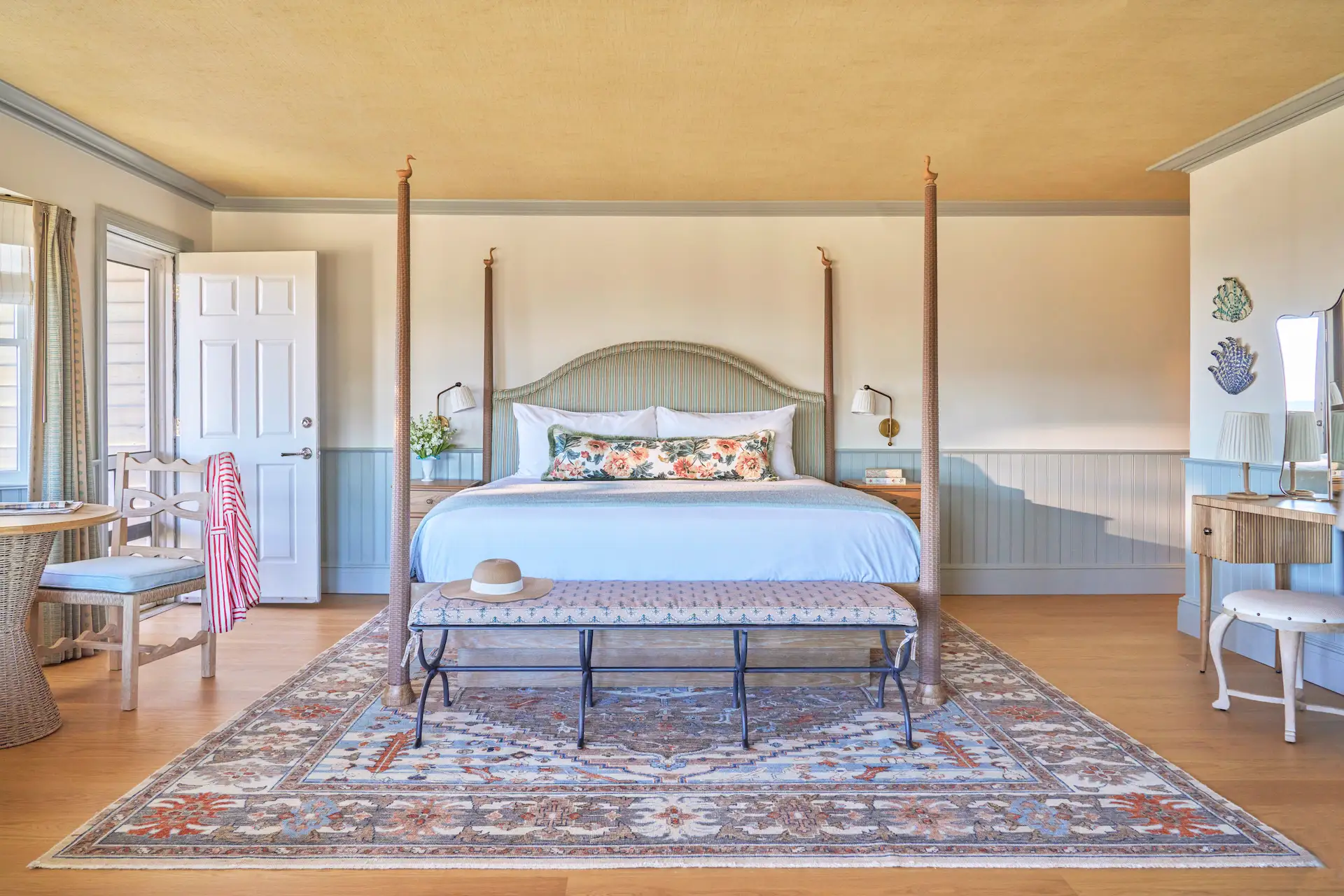 Elegant coastal-style King room at The Sanderling, featuring a four-poster bed, refined decor, and serene ambiance