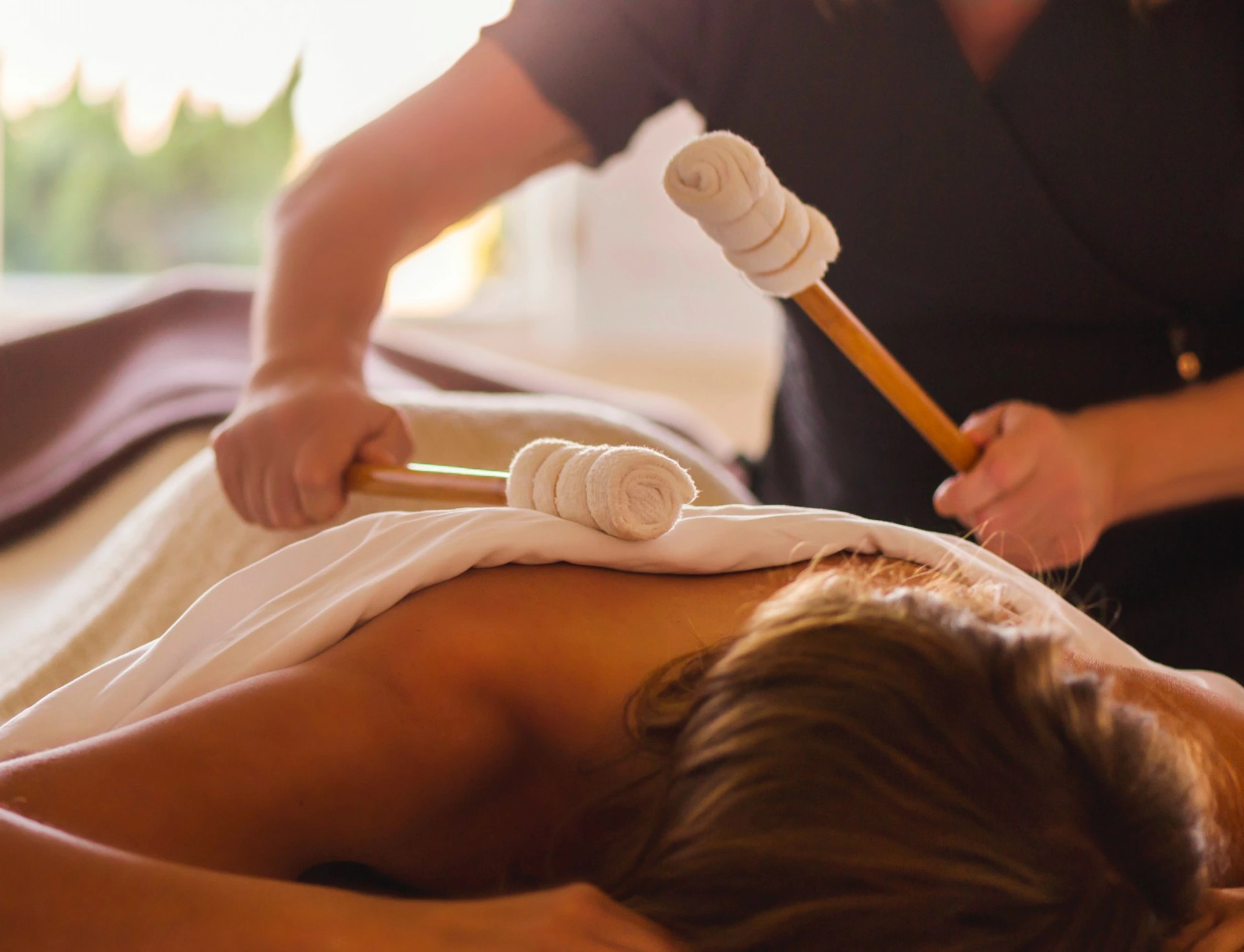 A guest at the Sanderling Hotel enjoys a relaxing massage in a serene setting.