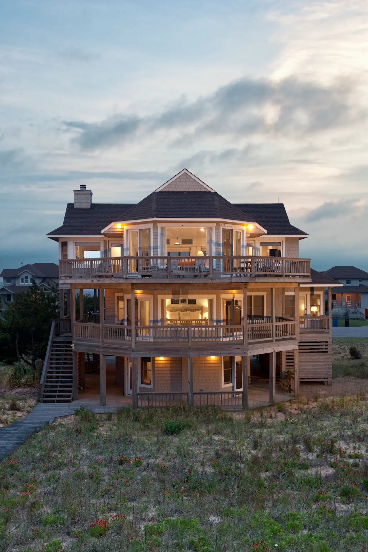 Exterior of Caffey House at dusk with multiple balconies and warm lighting