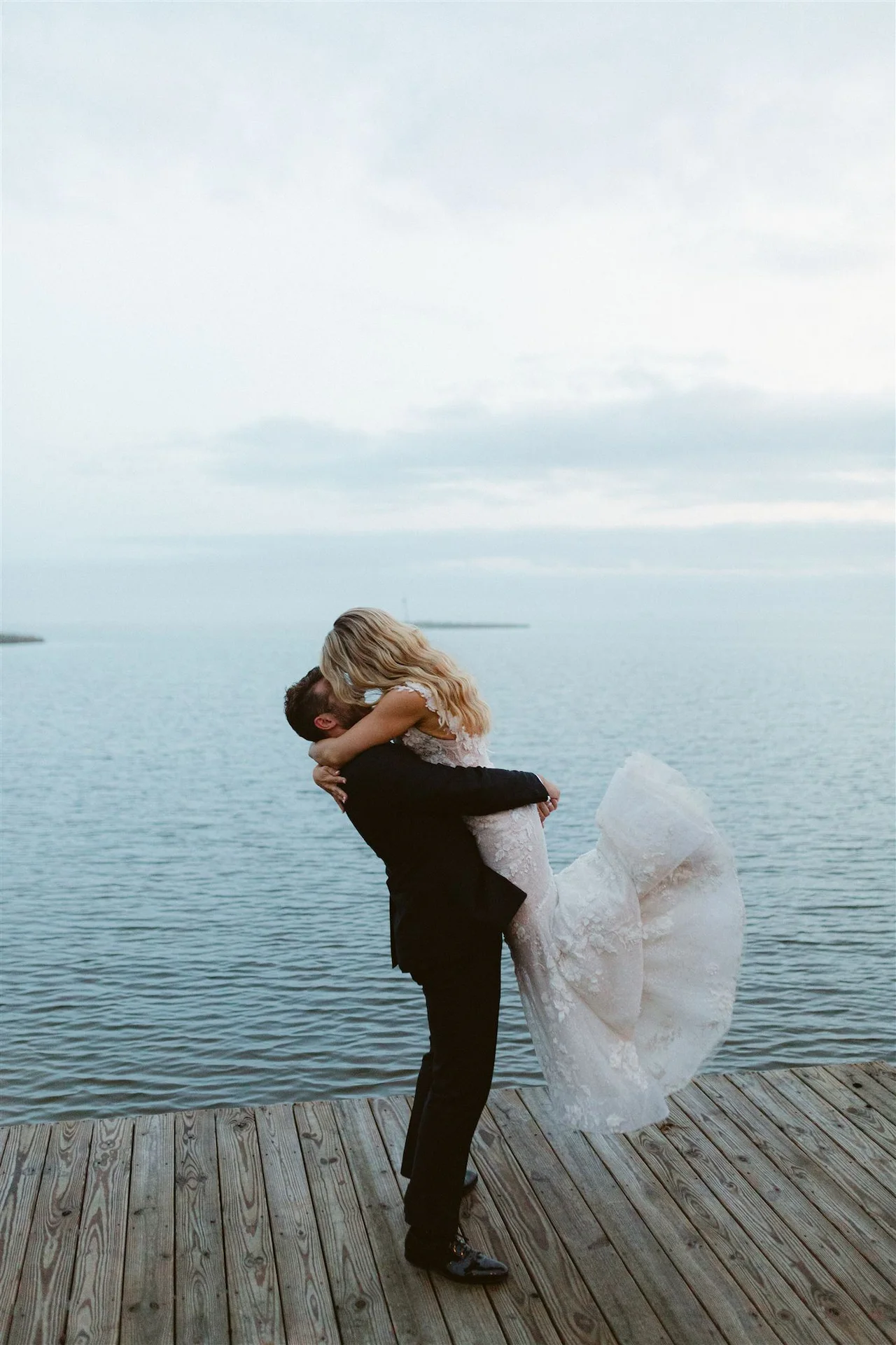 Tender and passionate embrace of a newlywed couple by the sea