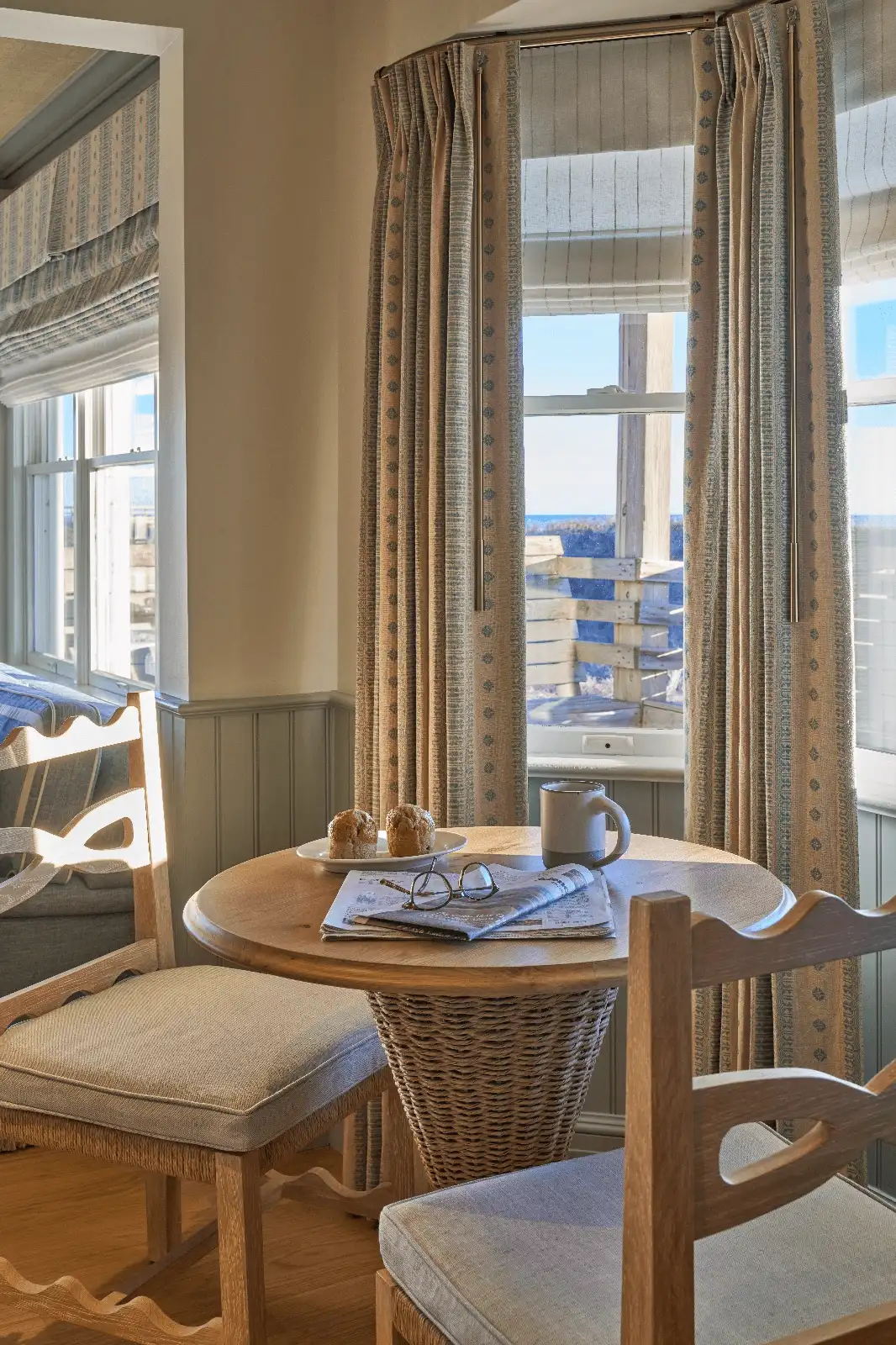 A corner of the room with a table and chair, perfect for relaxing with a coffee and reading the newspaper by the window with ocean views.